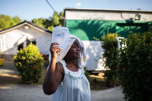 vrouw keert terug na een douche naar cholerabehandelcentrum Haïti