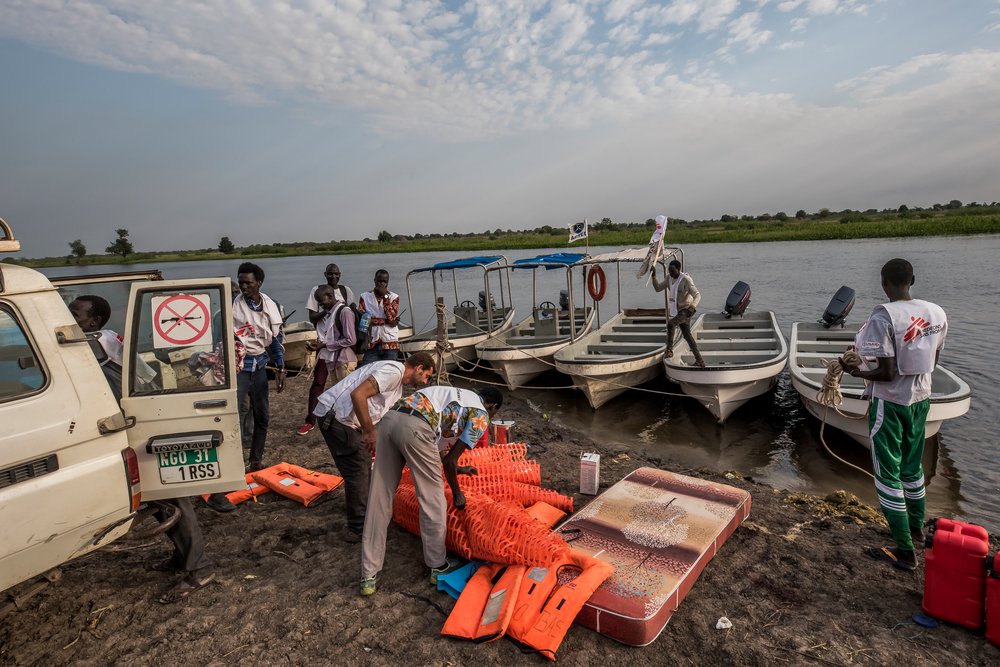 Aan de oever van de rivier Pibor in Zuid-Sudan worden alle spullen overgeladen op boten.