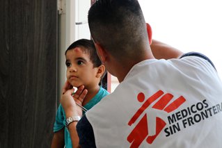 Venezolaans jongetje wordt geholpen door een van onze medewerkers